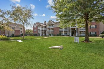 A grassy area in front of apartment buildings.